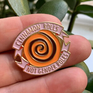 Brand new “Cinnamon Rolls, not Gender Roles” enamel pin